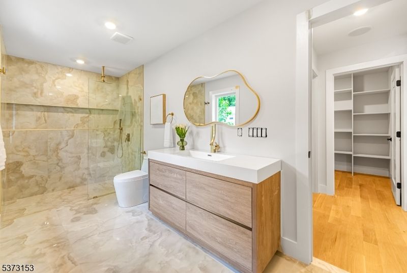 Bathroom, Dual Sink Vanities, Glass Shower, Interior, Marble, Recessed Lighting, Wood Texture Flooring