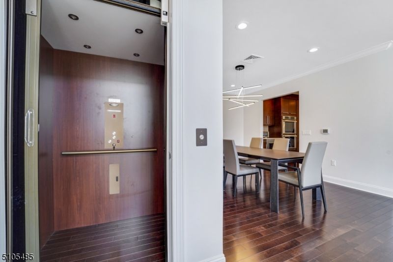 Dining room, Elevator, Interior, Kitchen, Pendant Lights, Recessed Lighting, Wood Texture Flooring