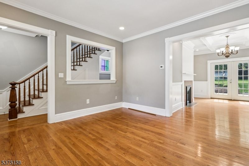 Chandelier, Empty room, Fireplace, Interior, Recessed Lighting, Wood Texture Flooring