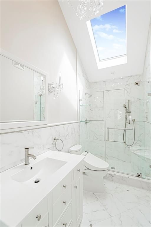 Bathroom, Dual Sink Vanities, Glass Ceilings, Glass Shower, Interior, Marble, Marble Walls, Recessed Lighting