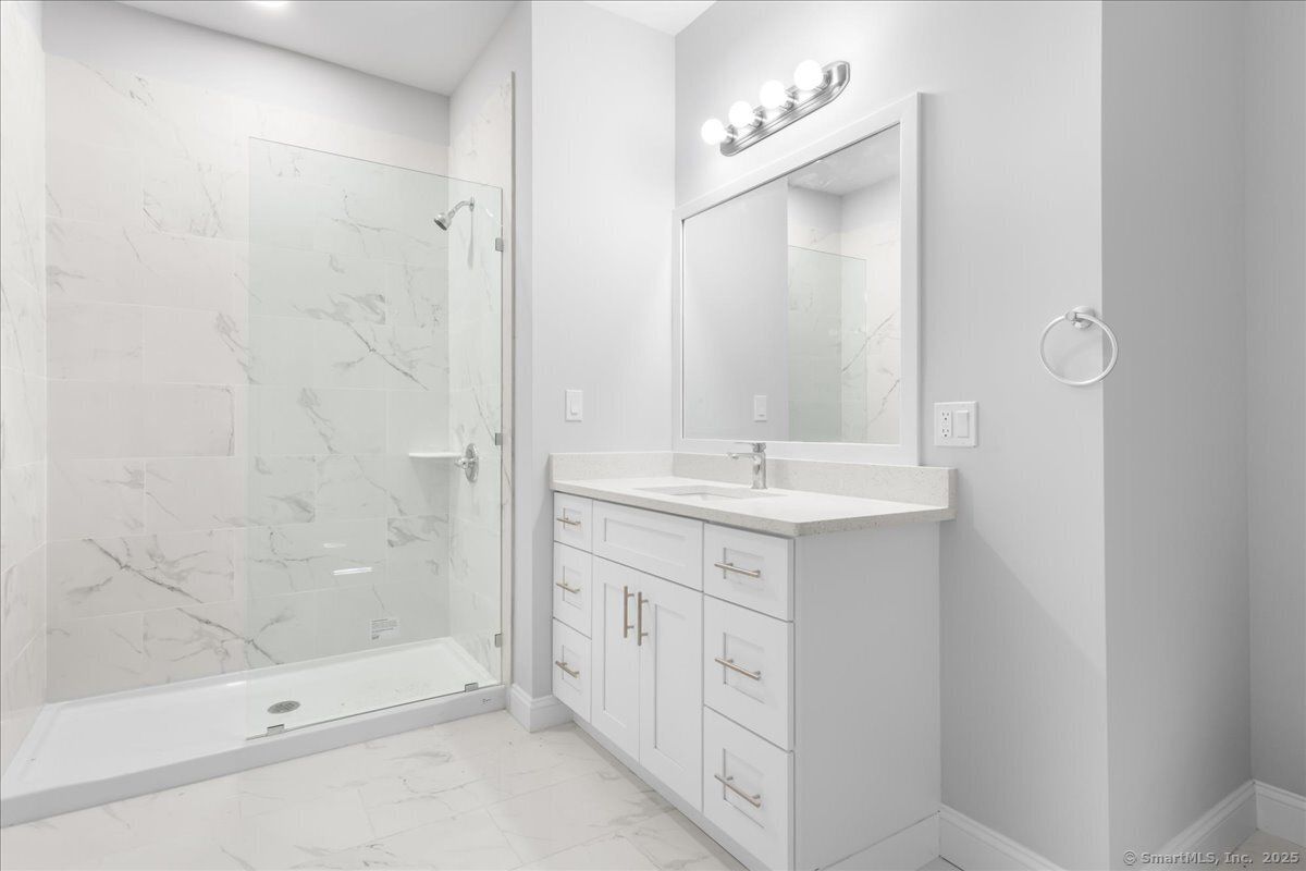 Bathroom, Dual Sink Vanities, Glass Shower, Interior, Marble, Marble Walls, Recessed Lighting