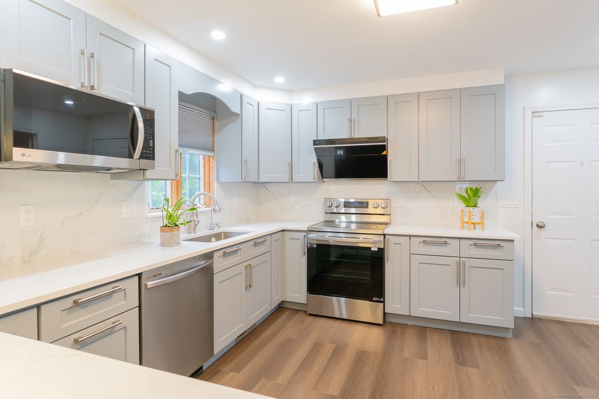 Interior, Kitchen, Marble Walls, Recessed Lighting, Stainless Steel Appliances, Wood Texture Flooring
