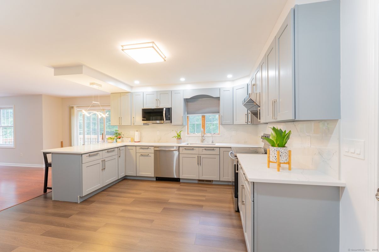 Interior, Kitchen, Marble Walls, Recessed Lighting, Stainless Steel Appliances, Wood Texture Flooring