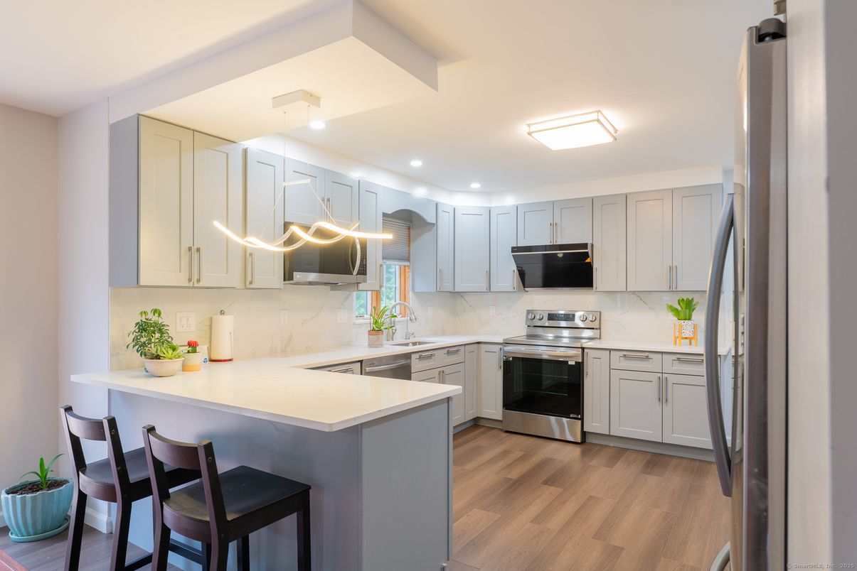 Interior, Kitchen, Marble Walls, Recessed Lighting, Stainless Steel Appliances, Wood Texture Flooring