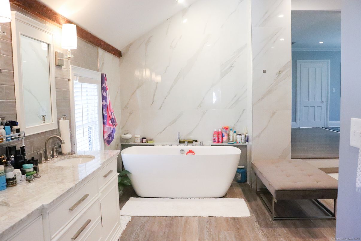 Bathroom, Dual Sink Vanities, Free Standing Baths, Interior, Marble Walls, Recessed Lighting, Wood Texture Flooring