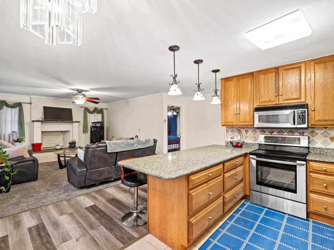 Fireplace, Interior, Kitchen, Living room, Pendant Lights, Stainless Steel Appliances, Wood Texture Flooring