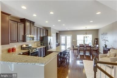 Chandelier, Dining room, Interior, Kitchen, Living room, Recessed Lighting, Stainless Steel Appliances, Wood Texture Flooring