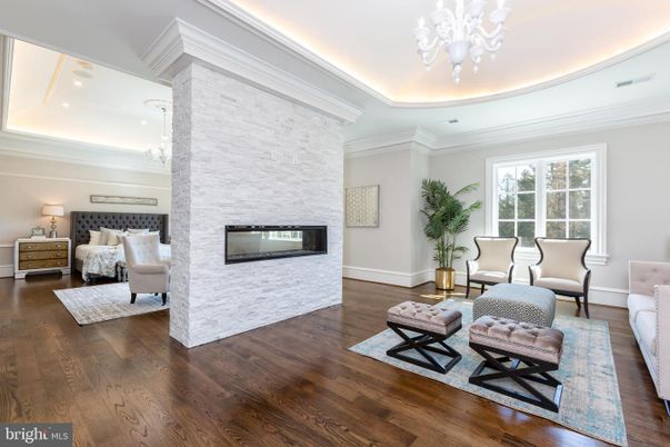 Bedroom, Chandelier, Fireplace, Interior, Recessed Lighting, Stone Walls, Wood Texture Flooring