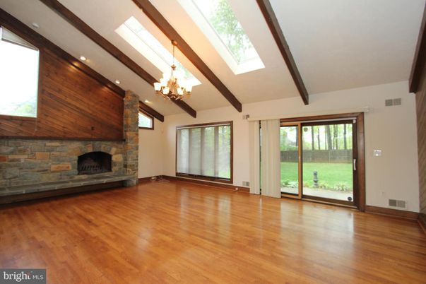 Chandelier, Empty room, Fireplace, Interior, Recessed Lighting, Wooden Beams, Wood Texture Flooring