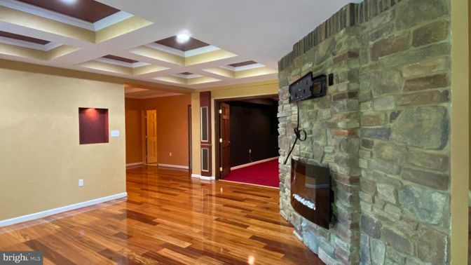 Empty room, Fireplace, Interior, Recessed Lighting, Stone Walls, Wood Texture Flooring