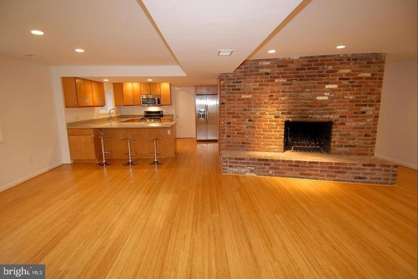 Fireplace, Interior, Kitchen, Recessed Lighting, Stainless Steel Appliances, Stone Walls, Wood Texture Flooring