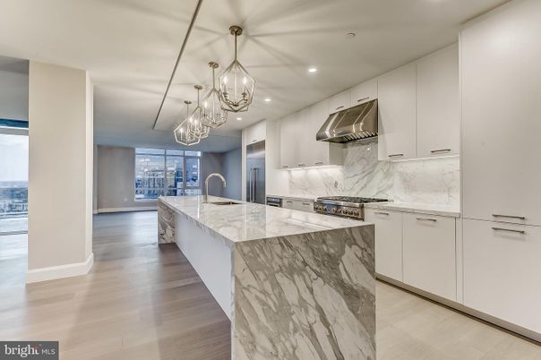 Chandelier, Interior, Kitchen, Marble Walls, Pendant Lights, Recessed Lighting, Stainless Steel Appliances, Wood Texture Flooring
