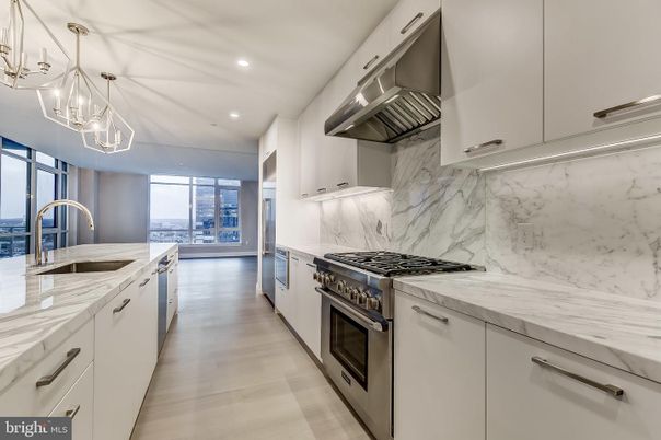 Chandelier, Interior, Kitchen, Marble Walls, Recessed Lighting, Stainless Steel Appliances, Wood Texture Flooring