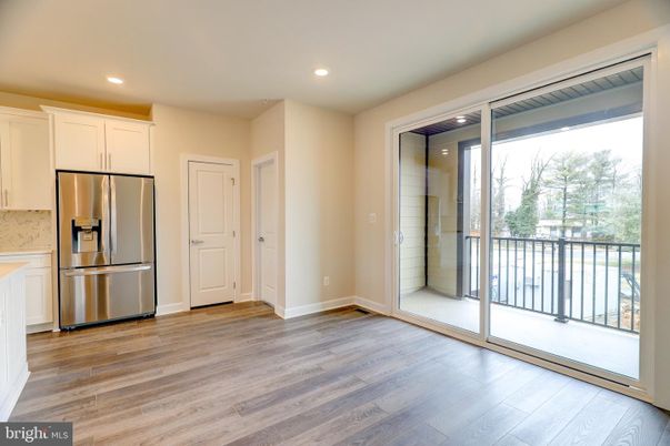 Empty room, Interior, Kitchen, Recessed Lighting, Stainless Steel Appliances, Wood Texture Flooring