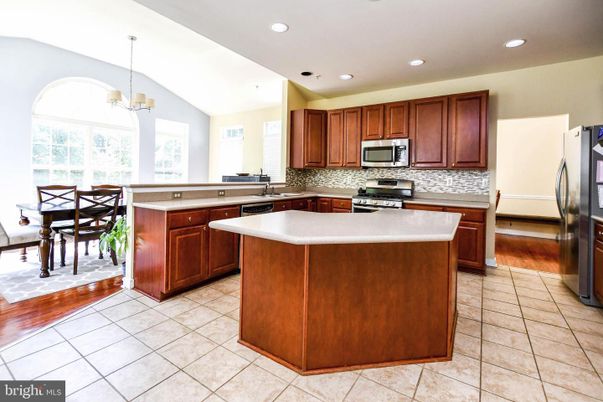 Chandelier, Dining room, Interior, Kitchen, Recessed Lighting, Stainless Steel Appliances, Wood Texture Flooring