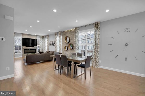 Dining room, Fireplace, Interior, Living room, Recessed Lighting, Stone Walls, Wood Texture Flooring