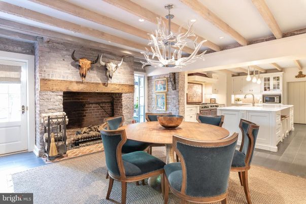 Chandelier, Dining room, Fireplace, Interior, Kitchen, Pendant Lights, Recessed Lighting, Stainless Steel Appliances, Stone Walls, Wooden Beams, Wood Texture Flooring