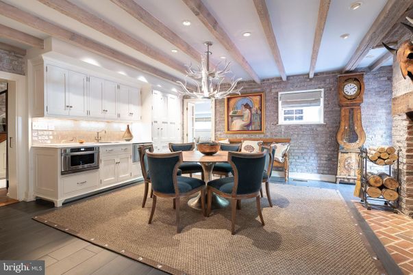 Chandelier, Dining room, Interior, Kitchen, Recessed Lighting, Stainless Steel Appliances, Stone Walls, Wooden Beams, Wood Texture Flooring