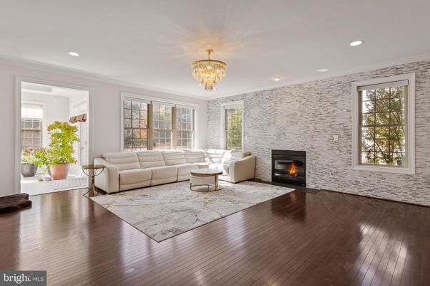 Chandelier, Fireplace, Interior, Living room, Recessed Lighting, Stone Walls, Wood Texture Flooring