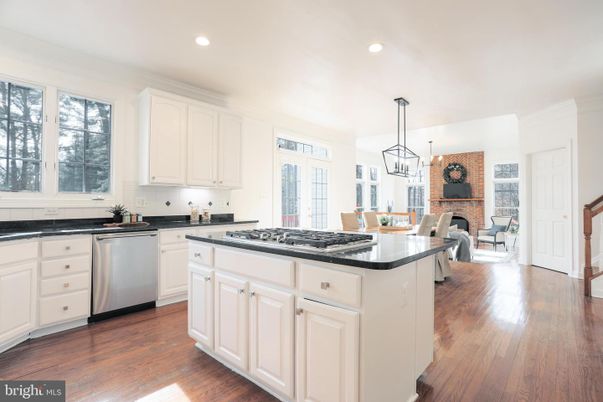 Dining room, Fireplace, Interior, Kitchen, Pendant Lights, Recessed Lighting, Stainless Steel Appliances, Stone Walls, Wood Texture Flooring