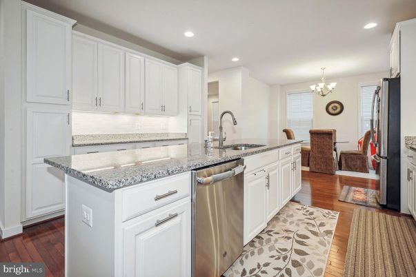 Chandelier, Dining room, Interior, Kitchen, Recessed Lighting, Stainless Steel Appliances, Wood Texture Flooring