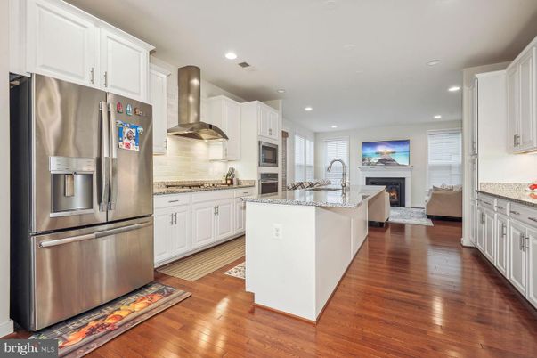 Fireplace, Interior, Kitchen, Living room, Recessed Lighting, Stainless Steel Appliances, Wood Texture Flooring