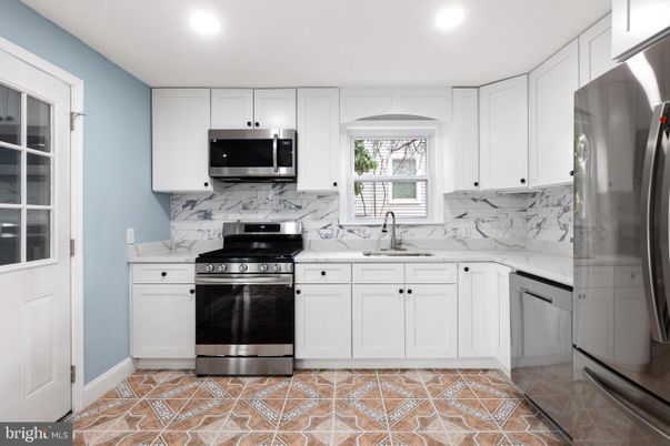 Interior, Kitchen, Marble Walls, Recessed Lighting, Stainless Steel Appliances
