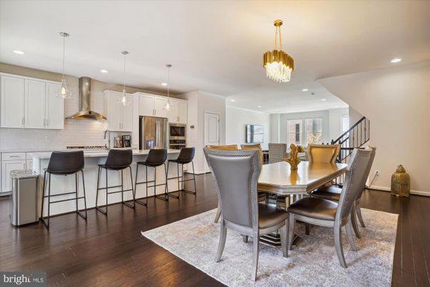 Chandelier, Dining room, Interior, Kitchen, Pendant Lights, Recessed Lighting, Stainless Steel Appliances, Wood Texture Flooring