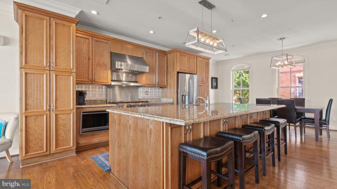 Chandelier, Dining room, Interior, Kitchen, Pendant Lights, Recessed Lighting, Stainless Steel Appliances, Wood Texture Flooring