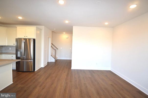 Empty room, Interior, Kitchen, Recessed Lighting, Stainless Steel Appliances, Wood Texture Flooring