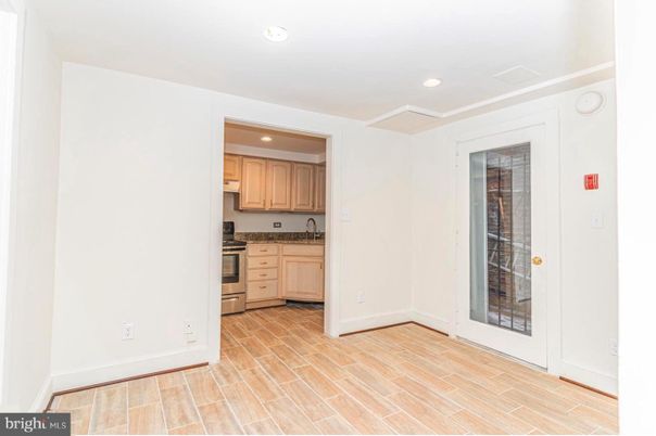 Empty room, Interior, Kitchen, Recessed Lighting, Stainless Steel Appliances, Wood Texture Flooring