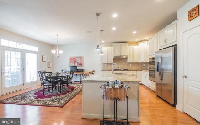 Chandelier, Dining room, Interior, Kitchen, Pendant Lights, Recessed Lighting, Stainless Steel Appliances, Wood Texture Flooring
