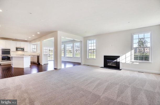 Empty room, Fireplace, Interior, Kitchen, Recessed Lighting, Stainless Steel Appliances, Wood Texture Flooring