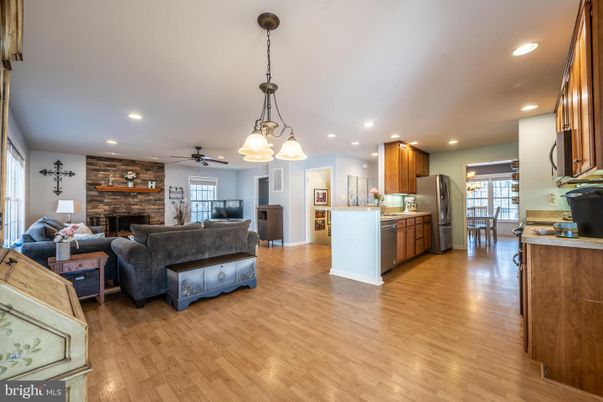 Dining room, Fireplace, Interior, Kitchen, Living room, Pendant Lights, Recessed Lighting, Stainless Steel Appliances, Stone Walls, Wood Texture Flooring