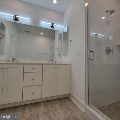 Bathroom, Dual Sink Vanities, Glass Shower, Interior, Recessed Lighting, Wood Texture Flooring
