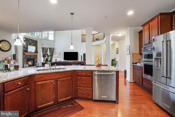 Fireplace, Interior, Kitchen, Pendant Lights, Recessed Lighting, Stainless Steel Appliances, Wood Texture Flooring