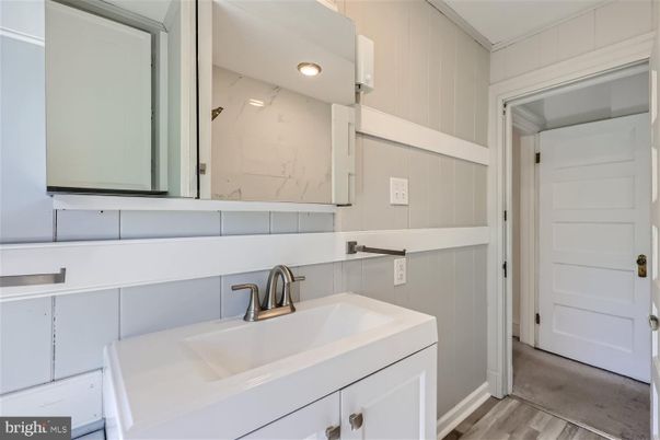 Bathroom, Dual Sink Vanities, Interior, Marble Walls, Wood Texture Flooring
