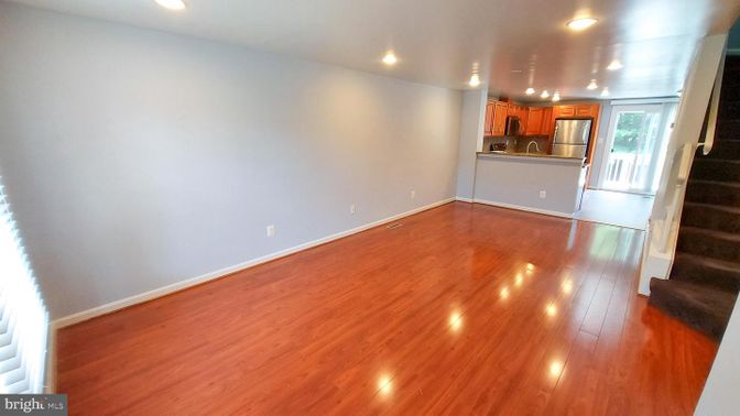 Empty room, Interior, Kitchen, Recessed Lighting, Stainless Steel Appliances, Wood Texture Flooring