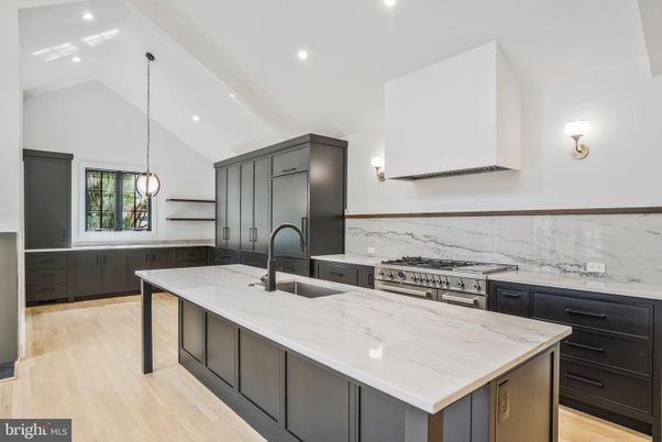 Interior, Kitchen, Marble Walls, Pendant Lights, Recessed Lighting, Stainless Steel Appliances, Wood Texture Flooring