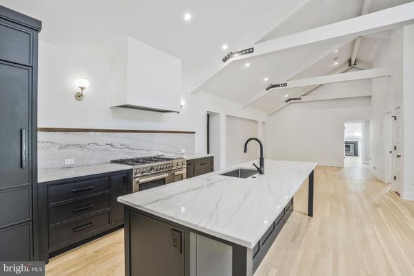 Interior, Kitchen, Marble Walls, Recessed Lighting, Stainless Steel Appliances, Wood Texture Flooring