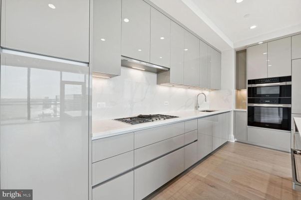Interior, Kitchen, Marble Walls, Recessed Lighting, Stainless Steel Appliances, Wood Texture Flooring