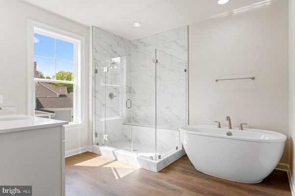 Bathroom, Free Standing Baths, Glass Shower, Interior, Marble Walls, Recessed Lighting, Wood Texture Flooring
