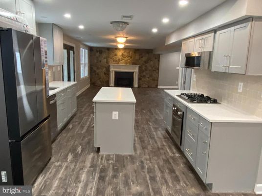 Fireplace, Interior, Kitchen, Recessed Lighting, Stainless Steel Appliances, Stone Walls, Wood Texture Flooring