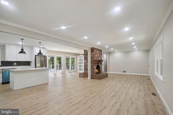 Empty room, Fireplace, Interior, Kitchen, Pendant Lights, Recessed Lighting, Stone Walls, Wood Texture Flooring