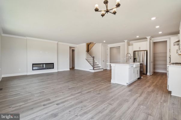 Empty room, Fireplace, Interior, Kitchen, Pendant Lights, Recessed Lighting, Stainless Steel Appliances, Wood Texture Flooring