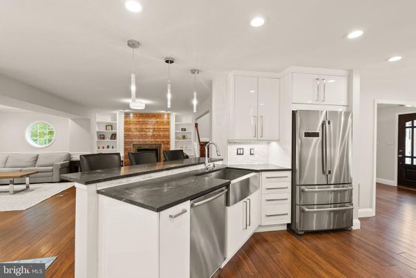 Fireplace, Interior, Kitchen, Living room, Pendant Lights, Recessed Lighting, Stainless Steel Appliances, Stone Walls, Wood Texture Flooring