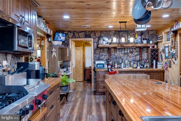 Interior, Kitchen, Pendant Lights, Recessed Lighting, Stainless Steel Appliances, Stone Walls, Wooden Ceilings, Wood Texture Flooring
