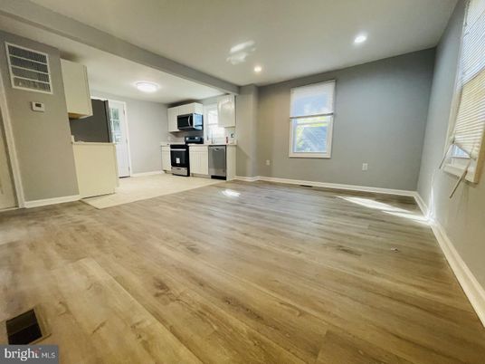 Empty room, Interior, Kitchen, Recessed Lighting, Stainless Steel Appliances, Wood Texture Flooring