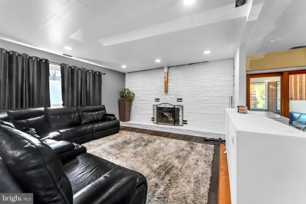 Fireplace, Interior, Living room, Recessed Lighting, Stone Walls, Wood Texture Flooring