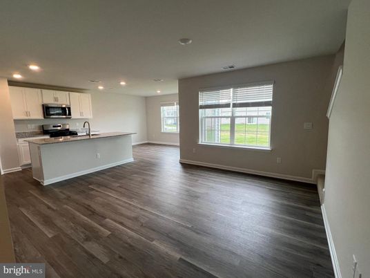 Empty room, Interior, Kitchen, Recessed Lighting, Stainless Steel Appliances, Wood Texture Flooring